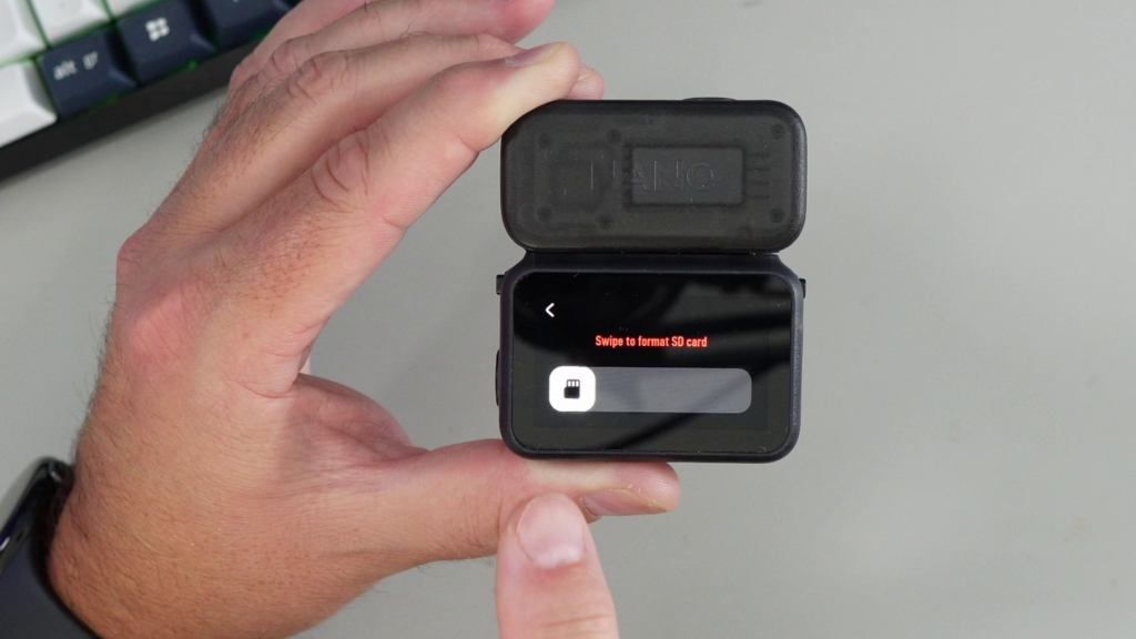 A close-up of the DJI Osmo Nano screen showing the final confirmation prompt, "Swipe to format SD card," before erasing the memory card.