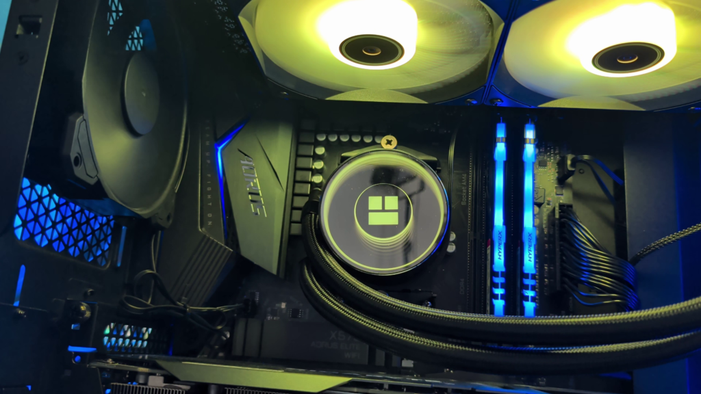 Thermalright Frozen Notte 240 AIO installed in a PC case with the pump hoses on the left side and the logo in an upside-down orientation for better RAM clearance.