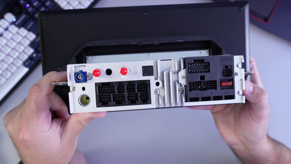 Rear connections on the Roadanvi X14 Android head unit showing wiring ports, antenna connections, and input/output connectors for Toyota RAV4 installation.